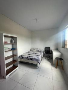 a bedroom with a bed and a desk in it at Apto Serras Gerais in Dianópolis