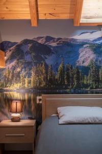 a bedroom with a mountain mural on the wall at le pragmatique in Guillestre