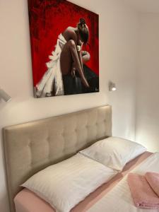 a bedroom with a painting above a bed at Apartments Oliva in Poreč