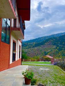 a brick building with a view of a yard at Holiday Borjomi in Borjomi