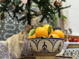 a bowl of oranges sitting on a table at Riad Mazar in Fez