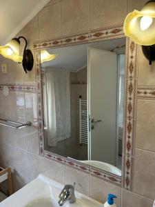 a bathroom with a sink and a mirror at Apartments Oliva in Poreč