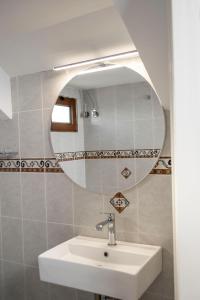 a bathroom with a sink and a mirror at Rokani Studio III in Kalavrita