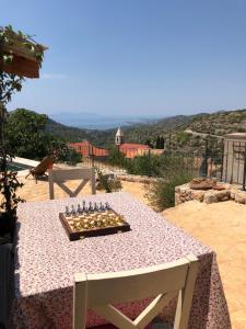 a table with a chess board on top of it at Peaceful & Secluded Retreat House Kod Kapetana Hvar in Veliko Grablje
