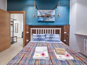 a bedroom with a large bed with two towels at Marina di Piazzadarmi in Ancona