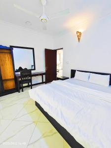 a bedroom with a large white bed and a window at Ayaa Luxury Apartment 3rd Floor Zanzibar in Ngambo