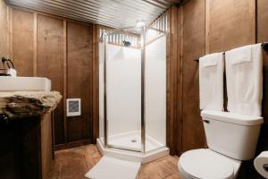 een badkamer met een douche en een toilet bij Cozy Unique Glamping on 53 acres - Bedrock Site in Branson