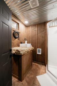 a bathroom with a sink and a toilet in it at Cozy Unique Glamping on 53 acres - Bedrock Site in Branson