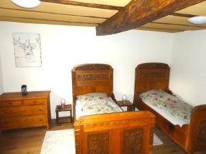a bedroom with two beds and a dresser at Alte Schreinerei in Lützelbach
