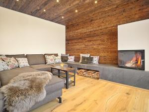a living room with a couch and a fireplace at The Mountain Hideaway 211 by AA Holiday Homes SKI IN SKI Out Die Tauplitz in Tauplitz