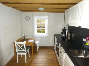 a kitchen with a table and a dining room at Alte Schreinerei in Lützelbach