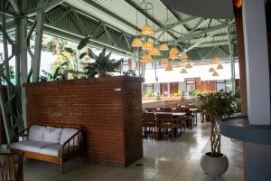 a restaurant with a brick wall and tables and chairs at Soy Local San José in San José