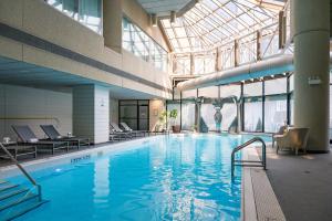 a large indoor swimming pool with a glass ceiling at InterContinental Toronto Centre, an IHG Hotel in Toronto