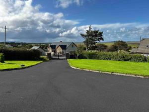 a driveway with a house in the middle of a yard at Atlantic Sea View in Tralee
