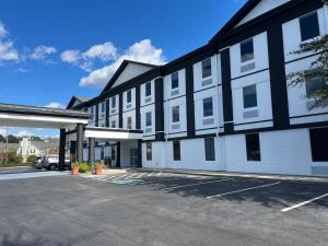 a large white and black building with a parking lot at The Grand Savannah Hotel in Savannah