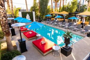 an overhead view of a pool with chairs and umbrellas at The Lexi Las Vegas in Las Vegas