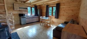 a living room with a couch and a table in a cabin at Winiec 218/8 in Miłomłyn