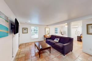 a living room with a couch and a coffee table at Old Northwood Cottage - A in West Palm Beach