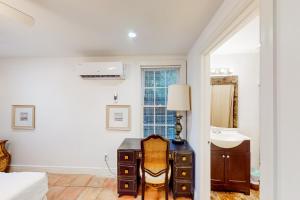 a bedroom with a desk and a sink in a room at Old Northwood Cottage - A in West Palm Beach