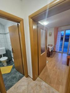 a hallway with two wooden doors and a room at Apartman M. Rados in Kupres