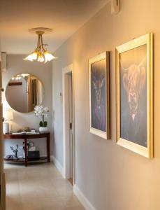 a hallway with three pictures on the wall at The Hillcrest, Luxury Accommodation in Castleblayney Town in Castleblayney