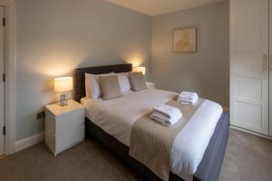 a bedroom with a bed with two towels on it at The Hillcrest, Luxury Accommodation in Castleblayney Town in Castleblayney