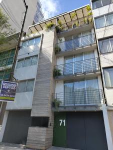 an apartment building with a sign in front of it at ZAMORA By Mr W in Mexico City +4 photos