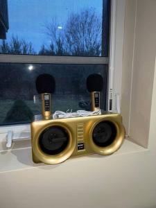 a radio sitting on a window sill with two speakers at 2 bedroom cozy entire ground floor in Vaughan