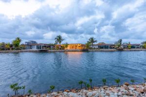 a house on the shore of a body of water at Seabird Luxury Dwellings in Placencia Village