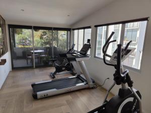 a gym with two exercise bikes and a treadmill at ZAMORA By Mr W in Mexico City