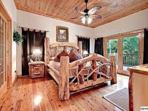 a bedroom with a wooden bed with a wooden ceiling at Providence Cabin in Townsend
