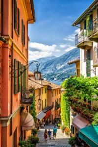 a group of people walking down a street between buildings at Ca' Sunin Bellagio - mountains view apartment in Bellagio