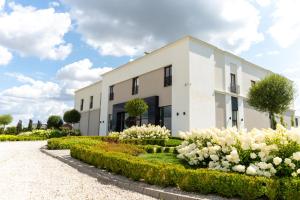 a white building with white flowers in front of it at MODERNO hotel Garwolin 