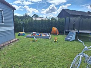 a backyard with a sandbox and a play set at Chillout in Smołdzino