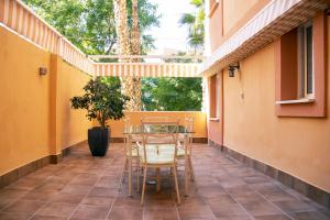 eine Terrasse mit einem Tisch und Stühlen auf dem Balkon in der Unterkunft La Antilla Dreams: Apartamento cerca del mar in Islantilla