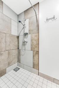 a shower in a bathroom with a tile wall at Juhkentali 46, korter 5 in Tallinn