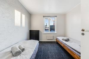 a bedroom with two beds and a window at Juhkentali 46, korter 5 in Tallinn