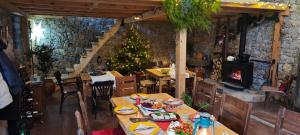 a dining room with a christmas tree in a restaurant at Chateau Orman in Orman