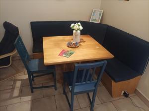 a table with two chairs and a vase of flowers on it at Central Apartment at Nagymezo street in Budapest