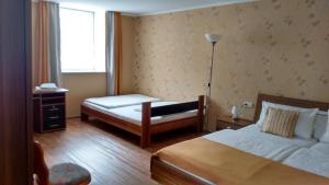 a hotel room with a bed and a desk and a window at Landgasthaus Oberbillig in Holsthum