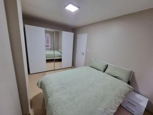 a bedroom with a large bed and a mirror at SweetPlace Forever in Charleroi (Appart2) in Charleroi