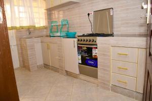 a kitchen with a stove and a counter top at Cozy 2 bedroom in Kitale-Fully Furnished at 360 Luxury in Kitale