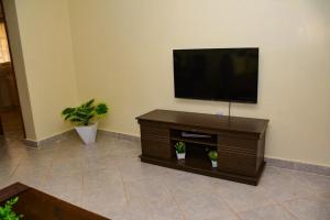 a living room with a flat screen tv on a wall at Cozy 2 bedroom in Kitale-Fully Furnished at 360 Luxury in Kitale