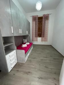a bedroom with a red bed and a window at Home Sweet Home in Guarrato