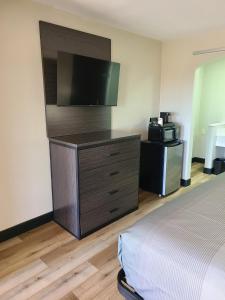 ein Hotelzimmer mit einem Bett und einem Flachbild-TV in der Unterkunft Quality Inn & Suites in Dumas