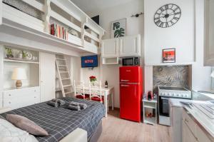 a small bedroom with a bed and a red refrigerator at Metro a 4 minuti Loft made in Italy with Free WiFi in Milan