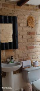 a bathroom with a white toilet and a sink at Encanto - Habitación con baño privado in Villa de Leyva