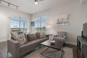 a living room with a couch and a table at Spacious 2br Corporate Suite, Parking, Pool Cs in Dallas