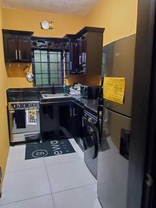 a kitchen with black cabinets and a stove top oven at Home Away From Home 