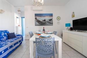 uma sala de estar com uma mesa e um sofá em Casa Luna 100 mt dalla spiaggia em Maruggio